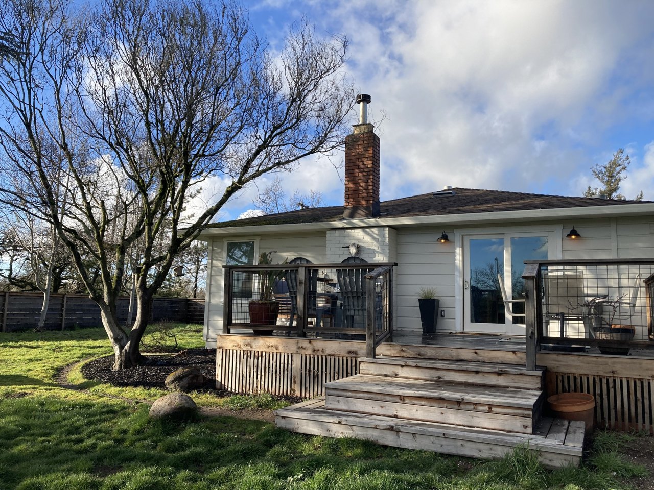House exterior showing siding, windows and a wood deck