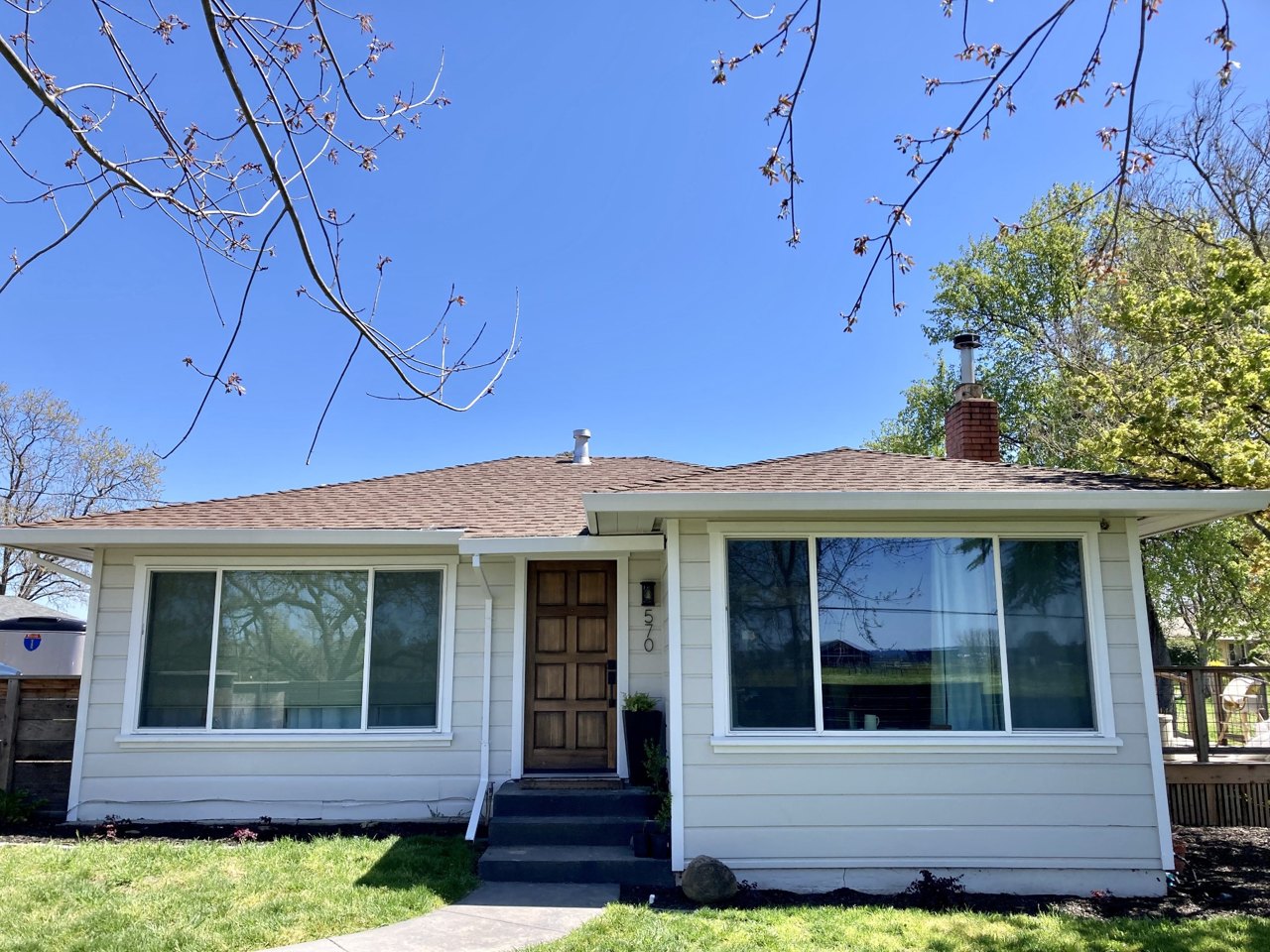 Finished house exterior with two large picture windows