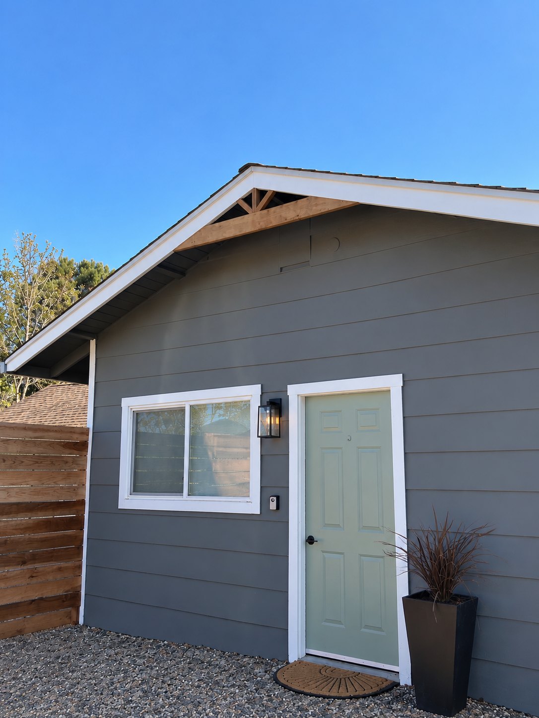 Gray siding with white window and door trim