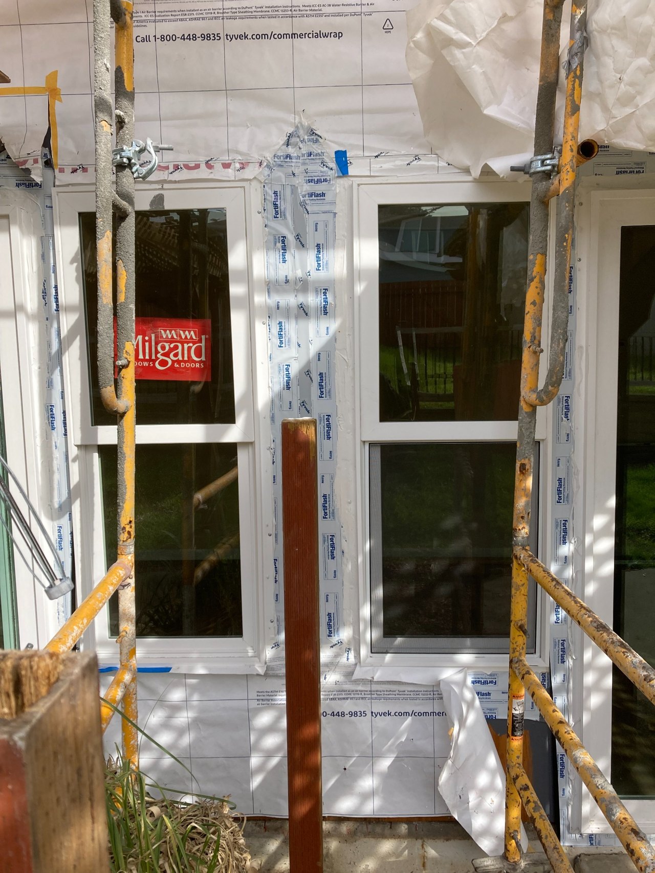 Door opening with flashing and weather protection exposed during installation